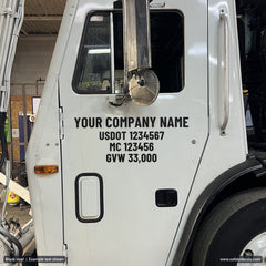 Die-cut USDOT number decal in black vinyl on a white truck door
