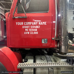 White reflective USDOT and MC lettering on a red truck door